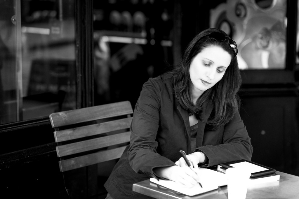 J.F.Penn writing in a cafe